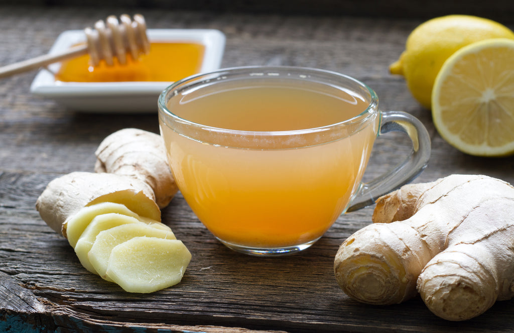Fresh ginger with tea made out of ginger, honey and lemon